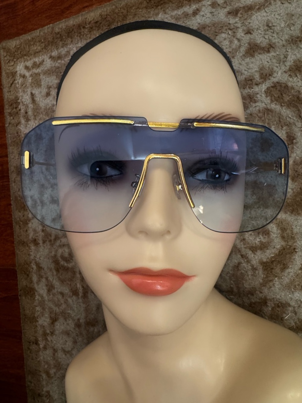 Blue lens sunglasses with gold details futuristic